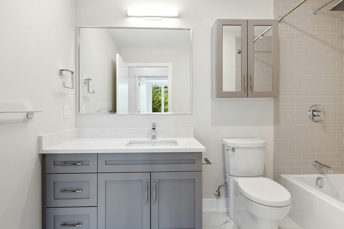Refaced bathroom vanity with gray Shaker doors and a quartz countertop, part of a Refacely tune-up add-on in Denver.