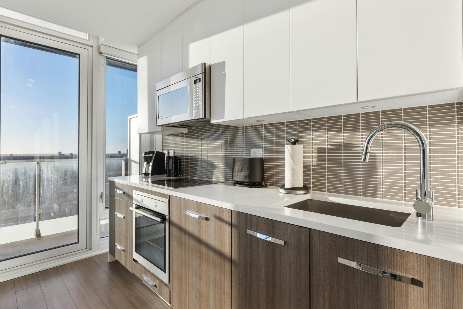 Finished Denver kitchen with wood-grain lower cabinets and white upper cabinets after refacing