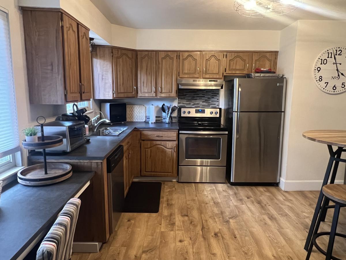 Kitchen before cabinet refacing — original oak cabinets.