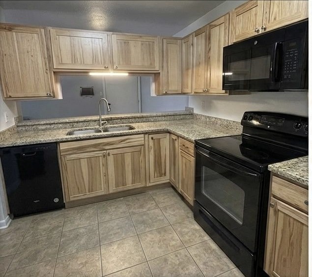 Before: Lisa S.'s Denver kitchen with dated honey oak cabinets, from her Google review photo.